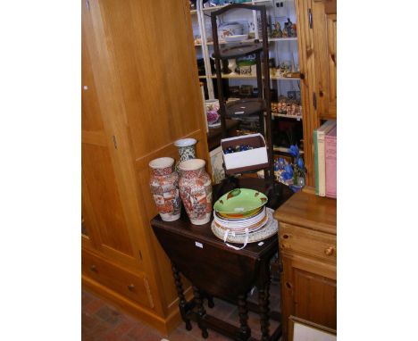 An oak gate-leg oval table on barley twist supports, together with a three tier folding cake stand  