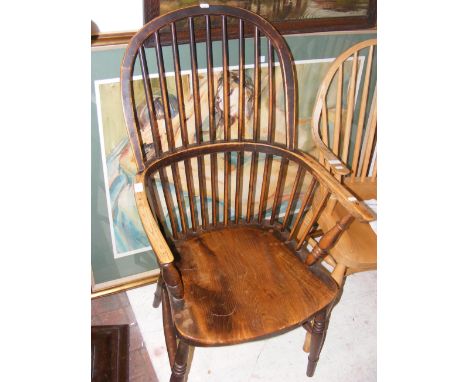 An antique high stick back country armchair