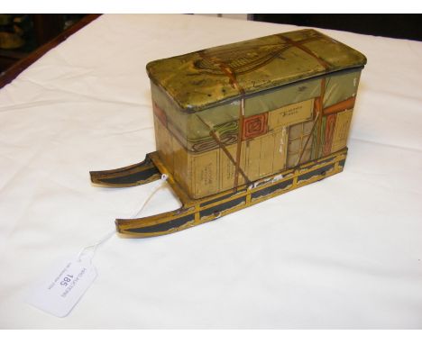 An unusual Jacob & Co. biscuit tin fashioned in the form of a crate on sledge - 18cms long CONDITION REPORT rear right wheel 