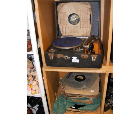 A vintage picnic gramophone, together with a quantity of shellac records - in two compartments 