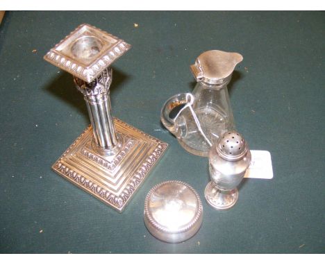 A silver candlestick, silver topped whisky noggin, pill box and spice shaker 