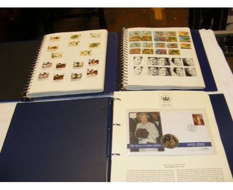 A stamp album containing GB collectable stamps, together with two others