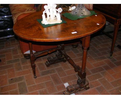 An unusual antique gate leg table with carved support