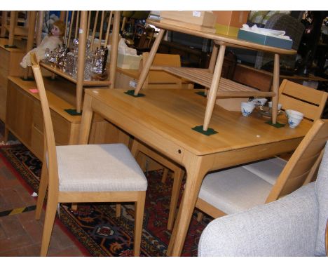 A contemporary Ercol 'Romana' extending dining table and four chairs - the un-extended length 111cm x 90cm