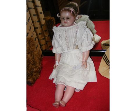 A Montanari poured wax shoulder head doll - circa 1860 with brown glass eyes and articulated cloth body, wax lower arms and l