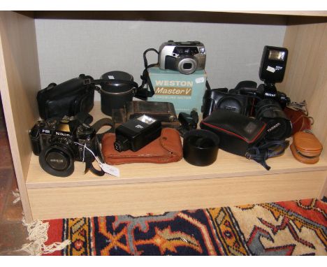 Vintage photographic equipment including Nikon F50 camera