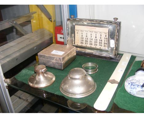 A silver framed calendar, cigarette box etc.
