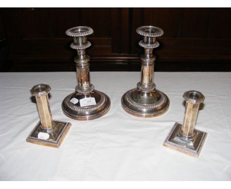 A pair of silver candlesticks, together with a pair of silver plated telescopic candlesticks