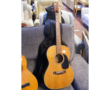 A Fender F-15 six string acoustic guitar with soft carrying case