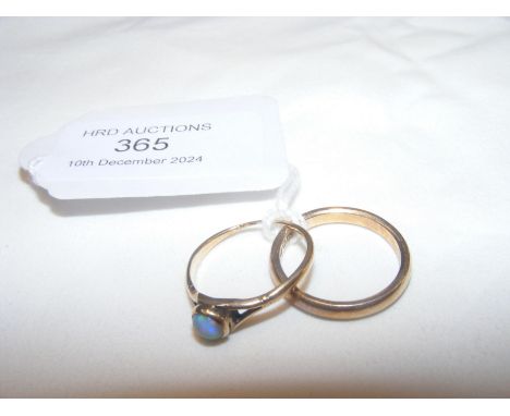 An opal ring in gold setting, together with wedding band