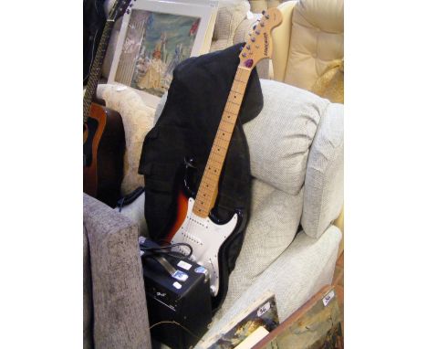 A Starcaster by Fender Strat six string electric guitar with soft carrying case and amplifier