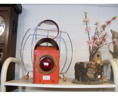 A vintage train signal lamp, together with mid century style newspaper rack 