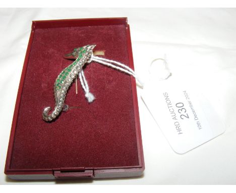 A solid silver 'seahorse' brooch/pendant with emerald mounted body