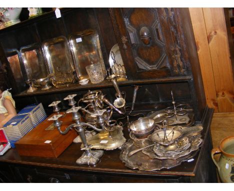 Silver plated candlesticks, a canteen of cutlery and other items - on two levels 