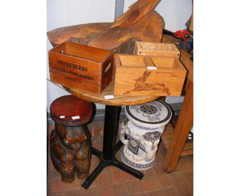 A circular pub table with three wooden cutlery boxes 