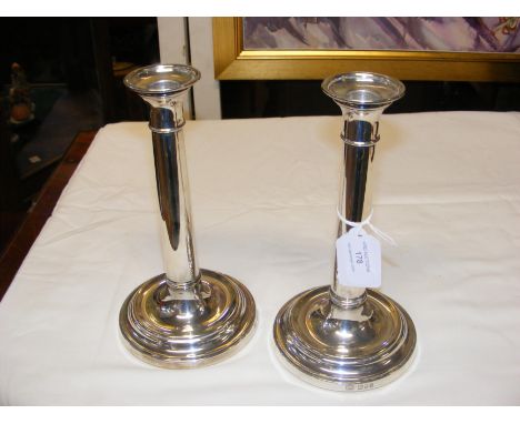 A pair of 22cm high silver candlesticks with London hallmark