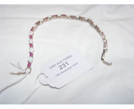 A silver opal and ruby bracelet