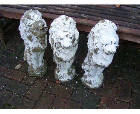 Three garden lion ornaments