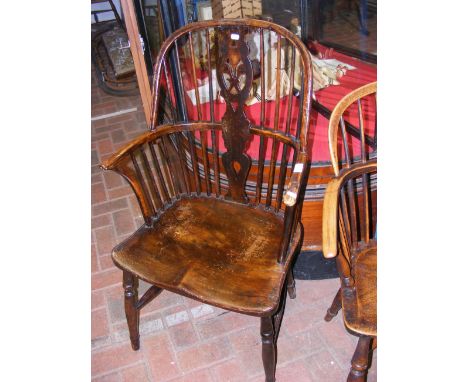 An antique high stick back armchair