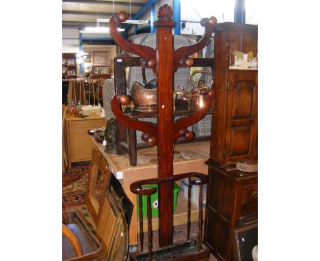 A mahogany coat and stick stand 