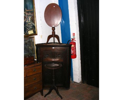 Two antique tripod tables, together with a carved oak corner cabinet