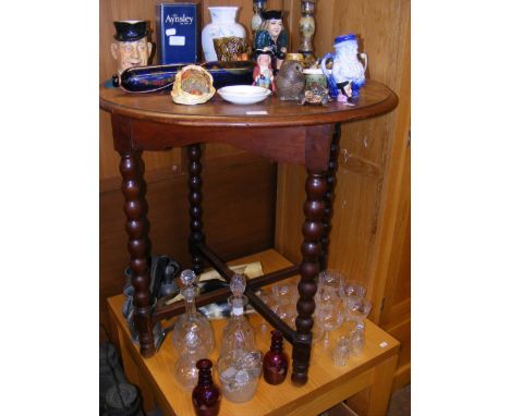 An oak circular table on bobbin supports 