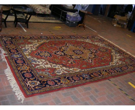 A large red ground carpet with abstract floral design - approx. 370cm x 240cm