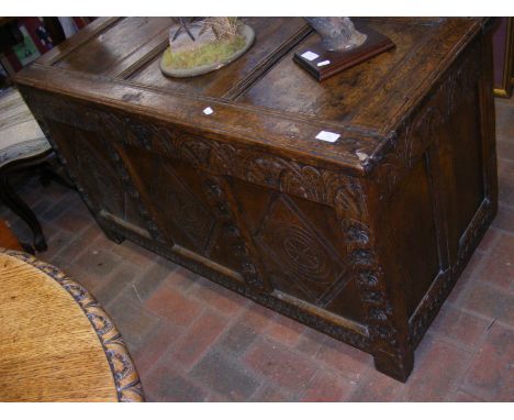 A period oak panelled coffer with carved front (lacking legs to the back)