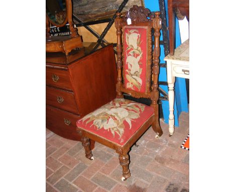 A 19th century carved hall chair with tapestry seat and back rest