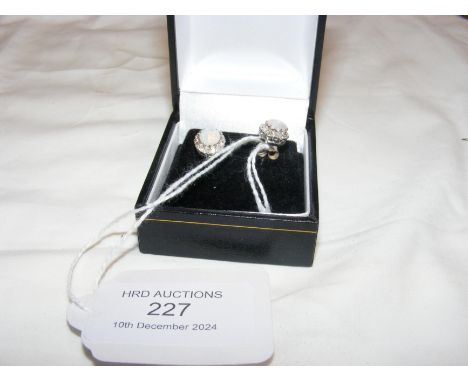 A pair of white gold diamond and opal cluster ear studs