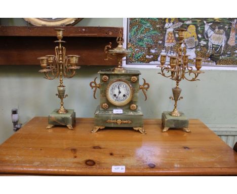 A French onyx and cast gilt metal clock garniture