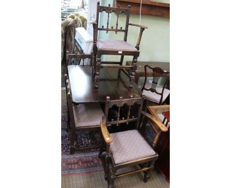 A drop leaf table together with four Ercol chairs