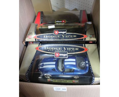 A box of Burago model cars, mostly boxed
