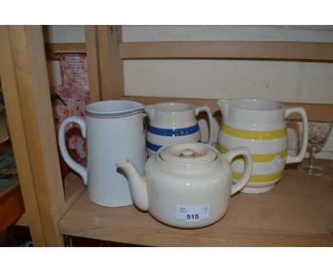 Two Cornish ware style jugs together with another and a teapot