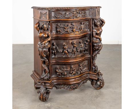 A Rococo-inspired commode with 3&nbsp;drawers and a small chest, richly sculptured with mythological&nbsp;figurines, putti an