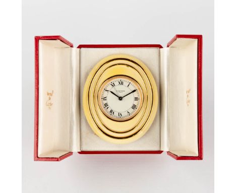 Cartier, a travel alarm clock, 7511 with the original box. The clock has some overall wear and craquelure to the paint.The bo