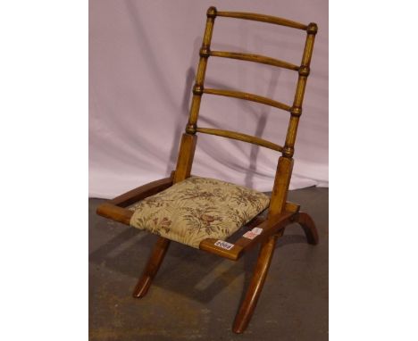 An Edwardian elm framed campaign chair, folding, with later upholstered seat, folding is secure, cushion has no tears/stains,