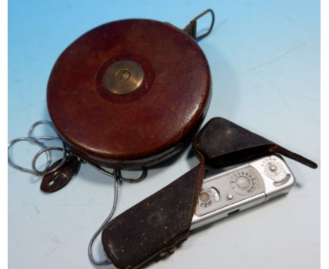 A Minox miniature camera (case in poor condition); a surveyor's leather cased measure