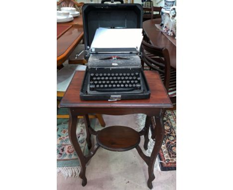 A mahogany occasional table with shelf below and a cased Royal typewriter