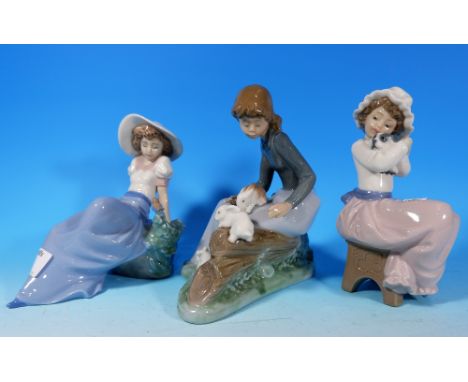 Three Nao figures of girls seated with pets, height 6"