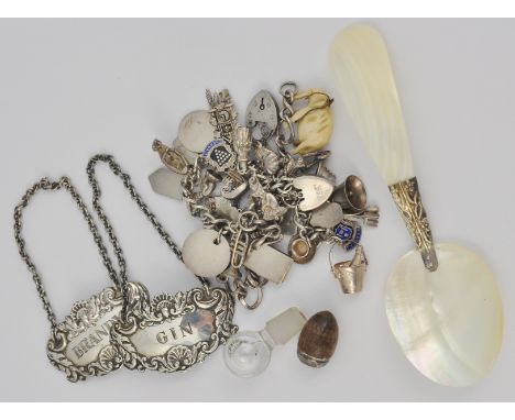 Silver charm bracelet, two silver decanter labels, chain bracelet, mother of pearl caddy spoon, etc.