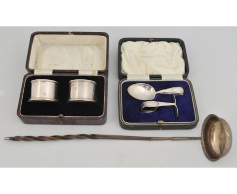 A late Georgian silver ladle twisted whalebone handle, silver child's pusher and spoon, cased, and a pair of silver napkin ri