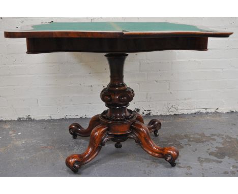 A Victorian walnut card table, serpentine fold-over top, carved column, scrolled legs, 94cm.