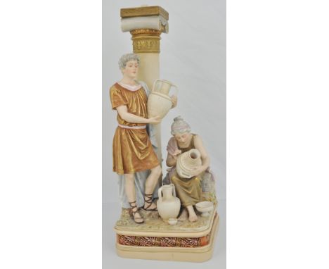 A Royal Dux style lamp column, with figures and water flagons, mark 291 to base, 40cms.