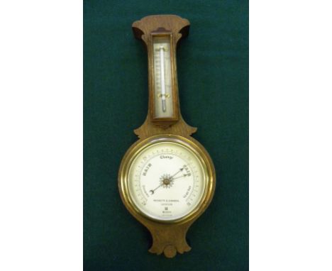 AN OAK ANEROID BAROMETER WITH THERMOMETER BY NEGRETTI & ZAMBRA, LONDON, NUMBERED R/11294, EARLY 20TH C