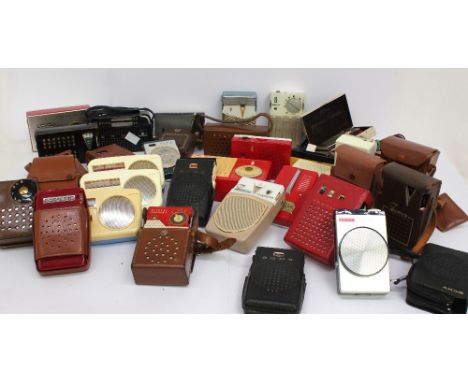 A mixed collection of various transistor radios, of various sizes and designs, portable size, pocket or slightly larger. Make