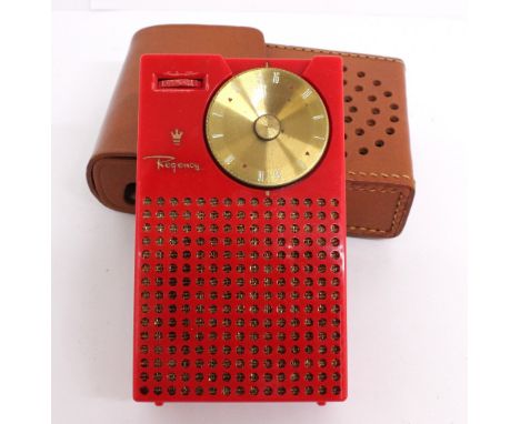 A vintage Regency model TR-1 pocket transistor radio, of red colourway with gold coloured detail, in an original tuck-tite le