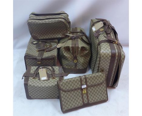 A matching eleven piece vintage Gucci hand luggage set, with repeating geometric patterns, hand stitched brown leather and me