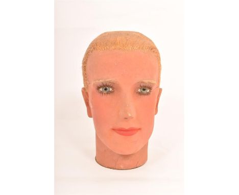 A Vintage c1920's/c1930's mannequin head, subject with synthetic blonde swept back hair in the pre war style with blue eyes a