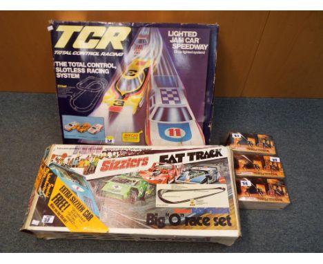 A Sizzlers Fat Track Big 'O' Race Set by Mattel model no.6009, boxed and a TCR Total Control Slot Racing System by Ideal, mod